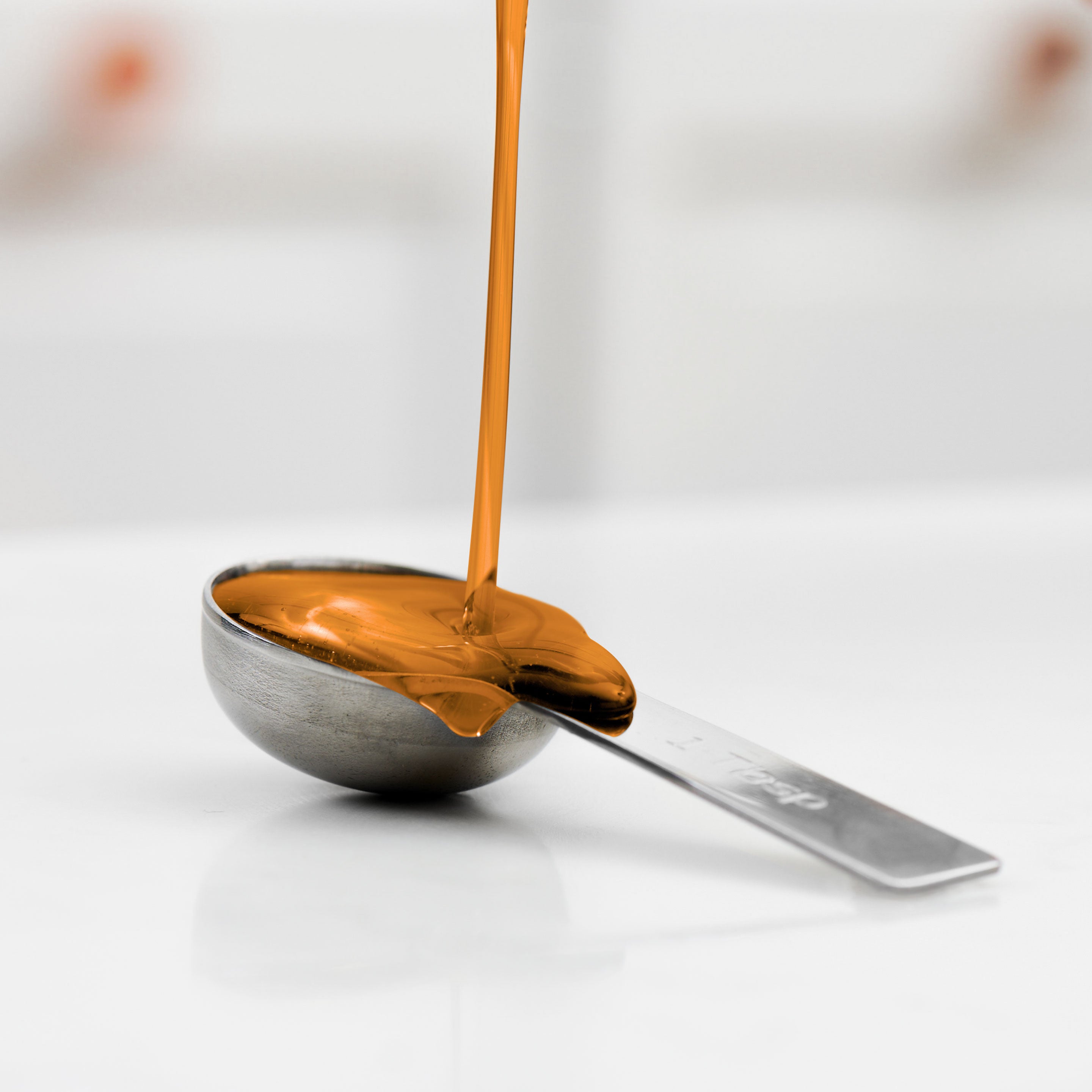 Simple Syrup pouring onto spoon