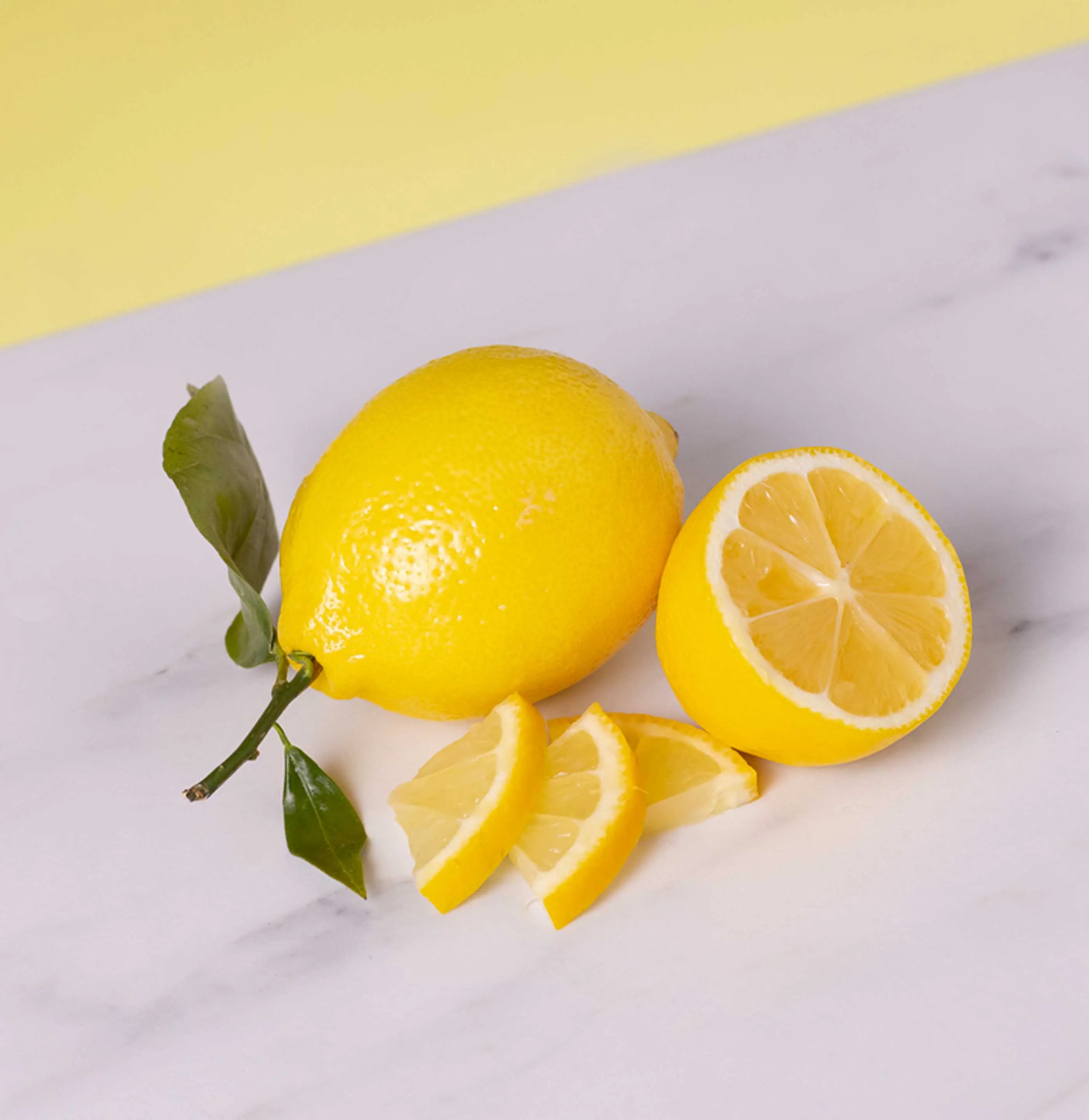 Lemon and sliced lemon on counter